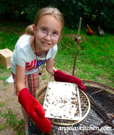 My littlest cooking assistant showing off Gluten & Dairy Free Box Oven S'more Brownie Bars